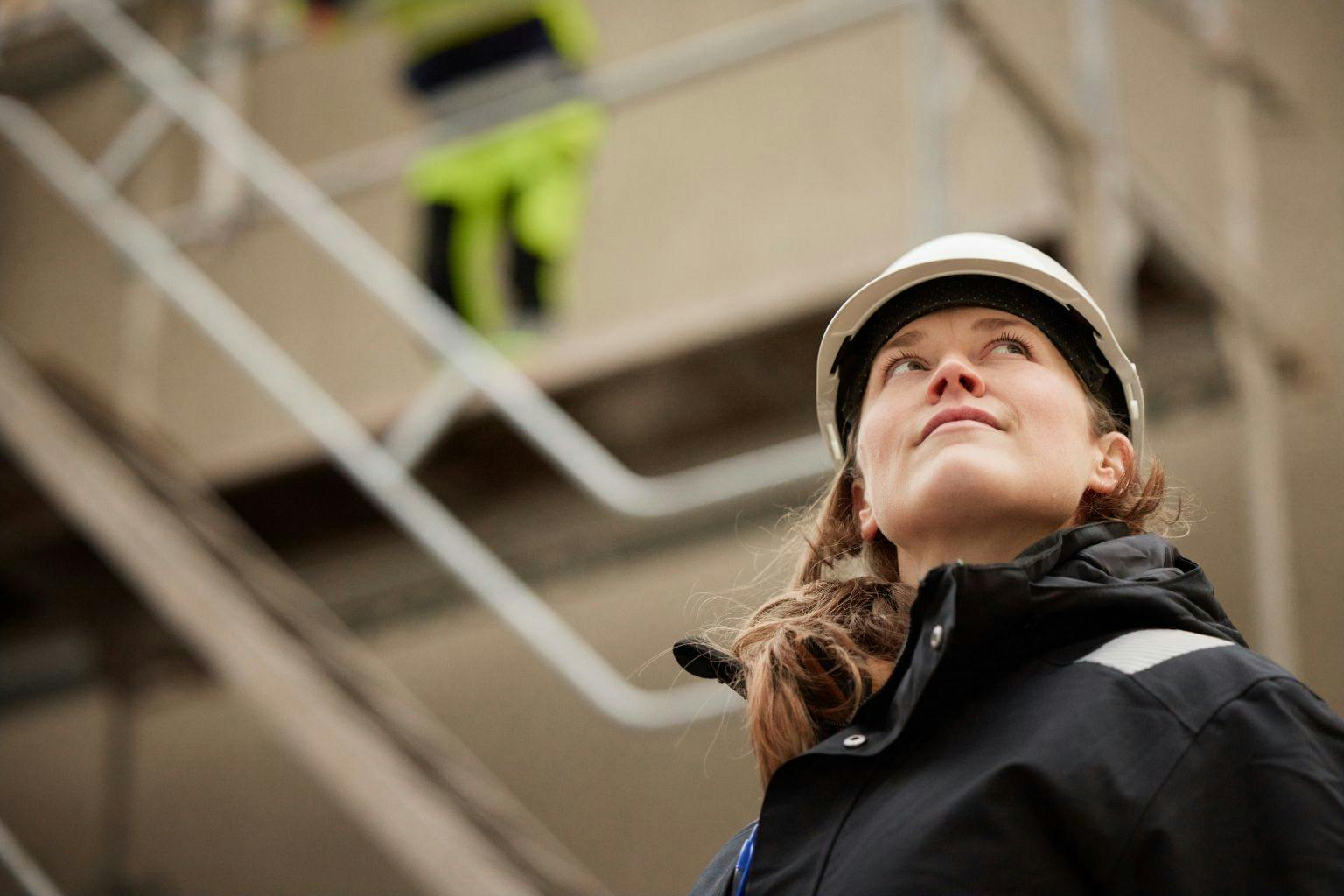 Women on work site with hard hat