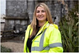 Head shot of woman in high-viz jacket, smiling at the camera 