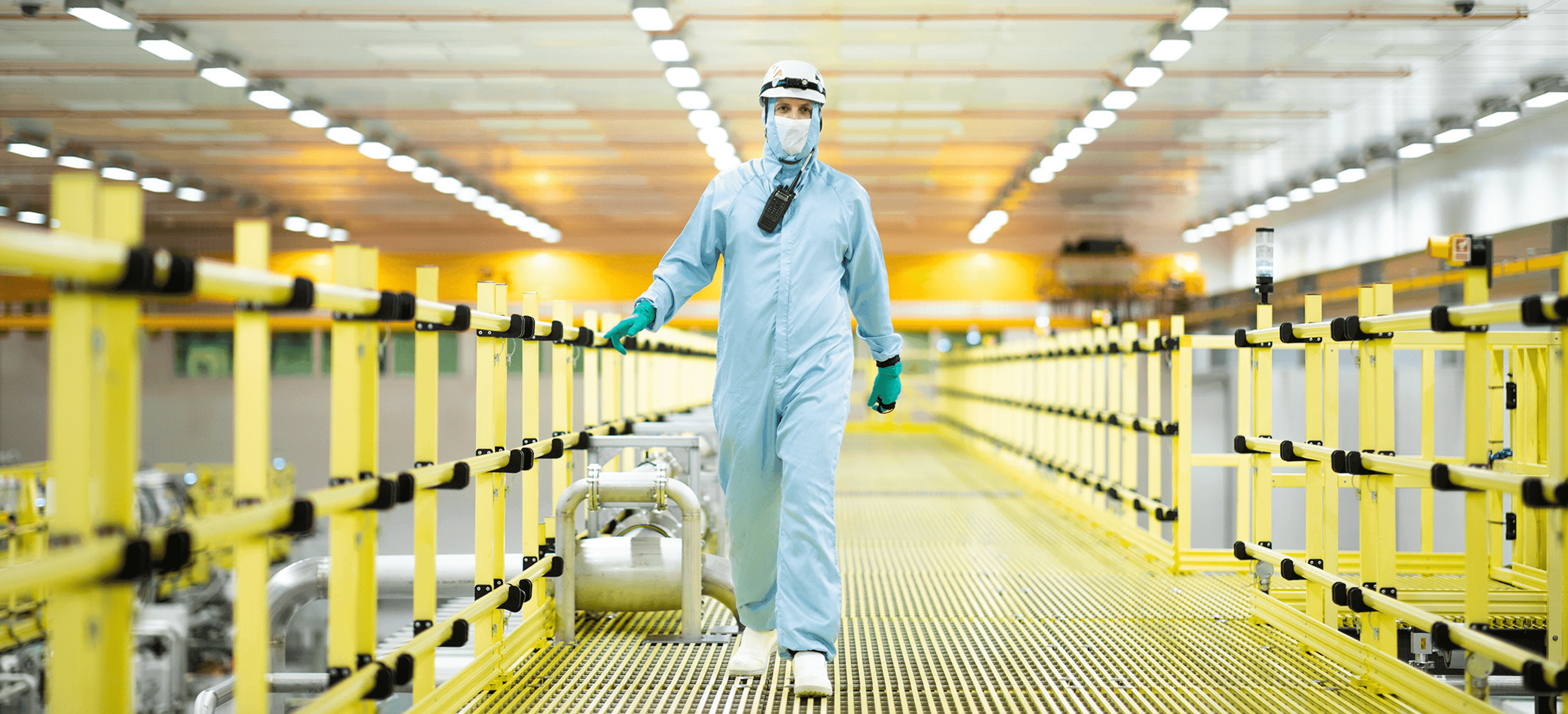 A man walking in a ramp in biohazard suit