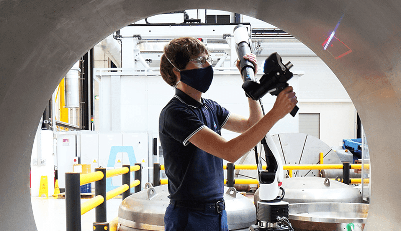 A man is working in a tube with laser
