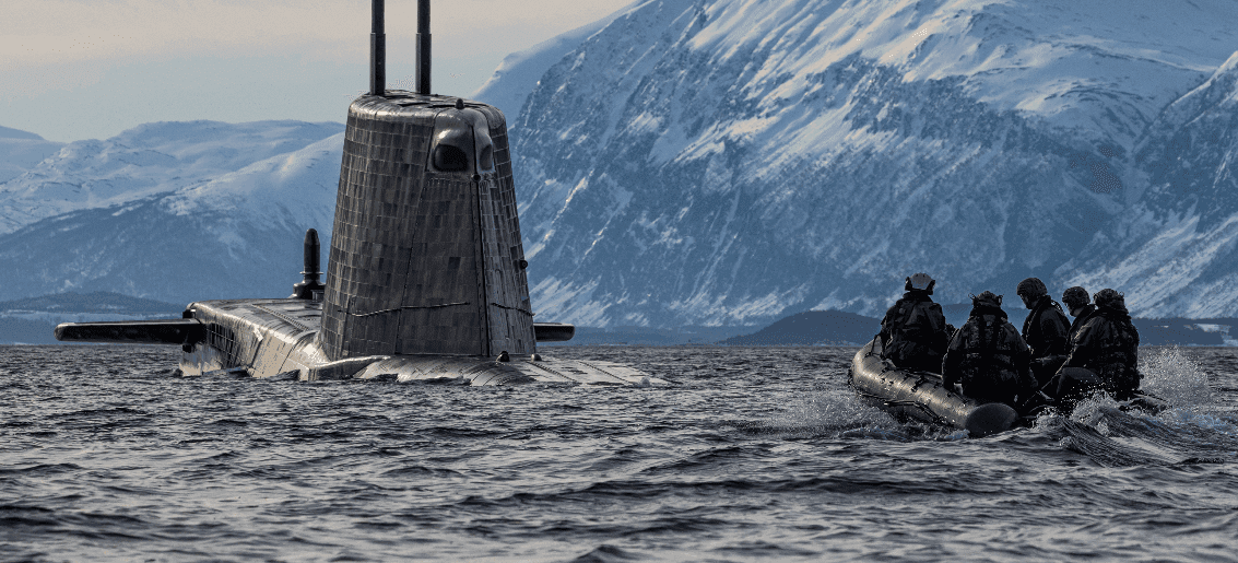 People approaching a submarine in a boat
